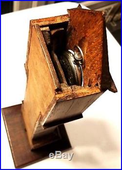 Antique Swiss pocket watch in wooden long-case holder